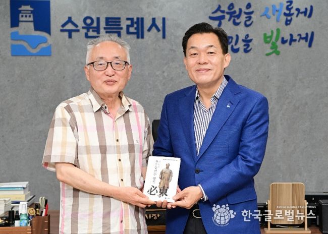 이재준 수원시장(오른쪽)과 박환 고려학술문화재단 이사장(왼쪽)이 평전을 들고 기념 촬영을 하고 있다.